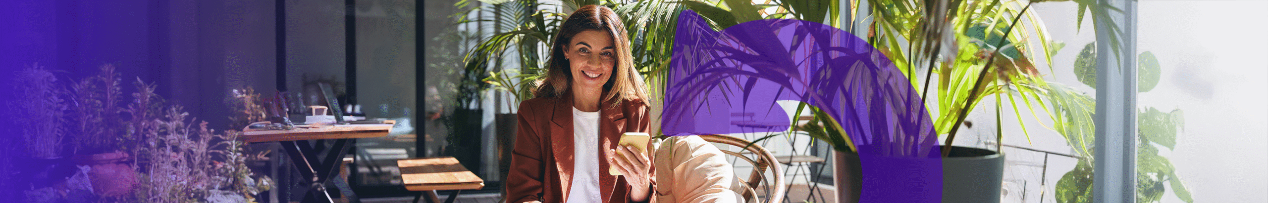 lady on her mobile in front of plants