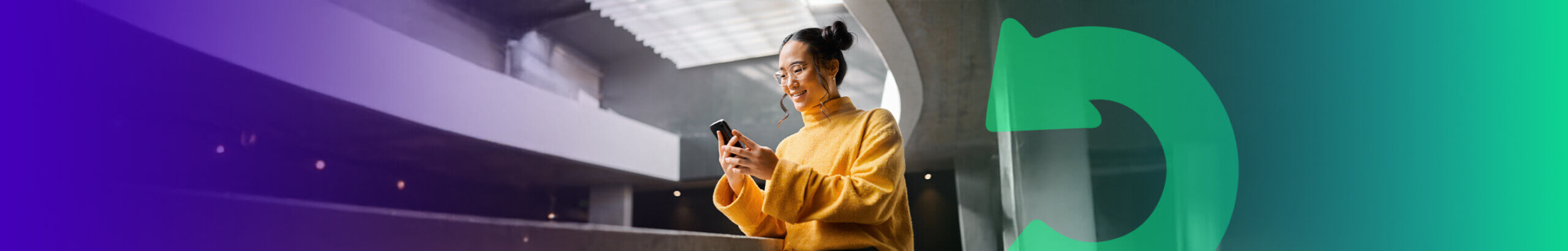 person in a yellow jumper using their mobile phone