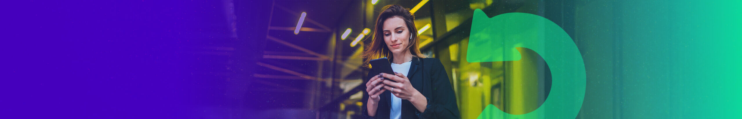 person using their mobile in front of yellow lights