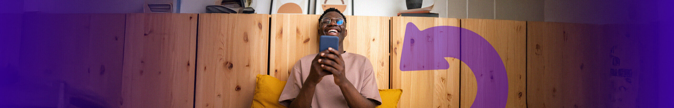 man sat on a bench using a blue mobile phone